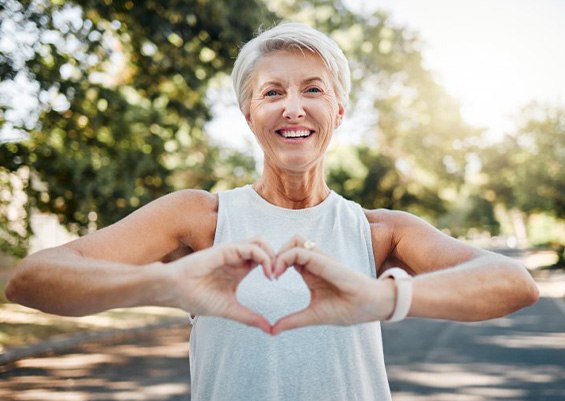 Lady makes shape of heart with her hands