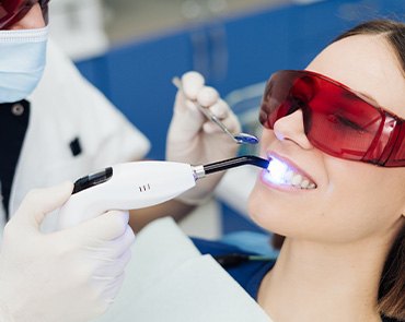 A woman receiving in-office teeth whitening