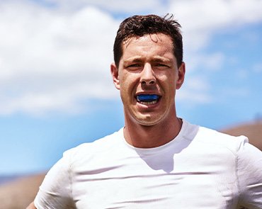 Man wears athletic mouthguard