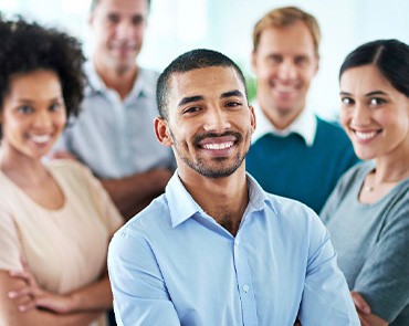 People standing together in workplace with arms crossed