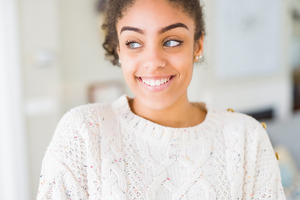 Woman in sweater showing her smile